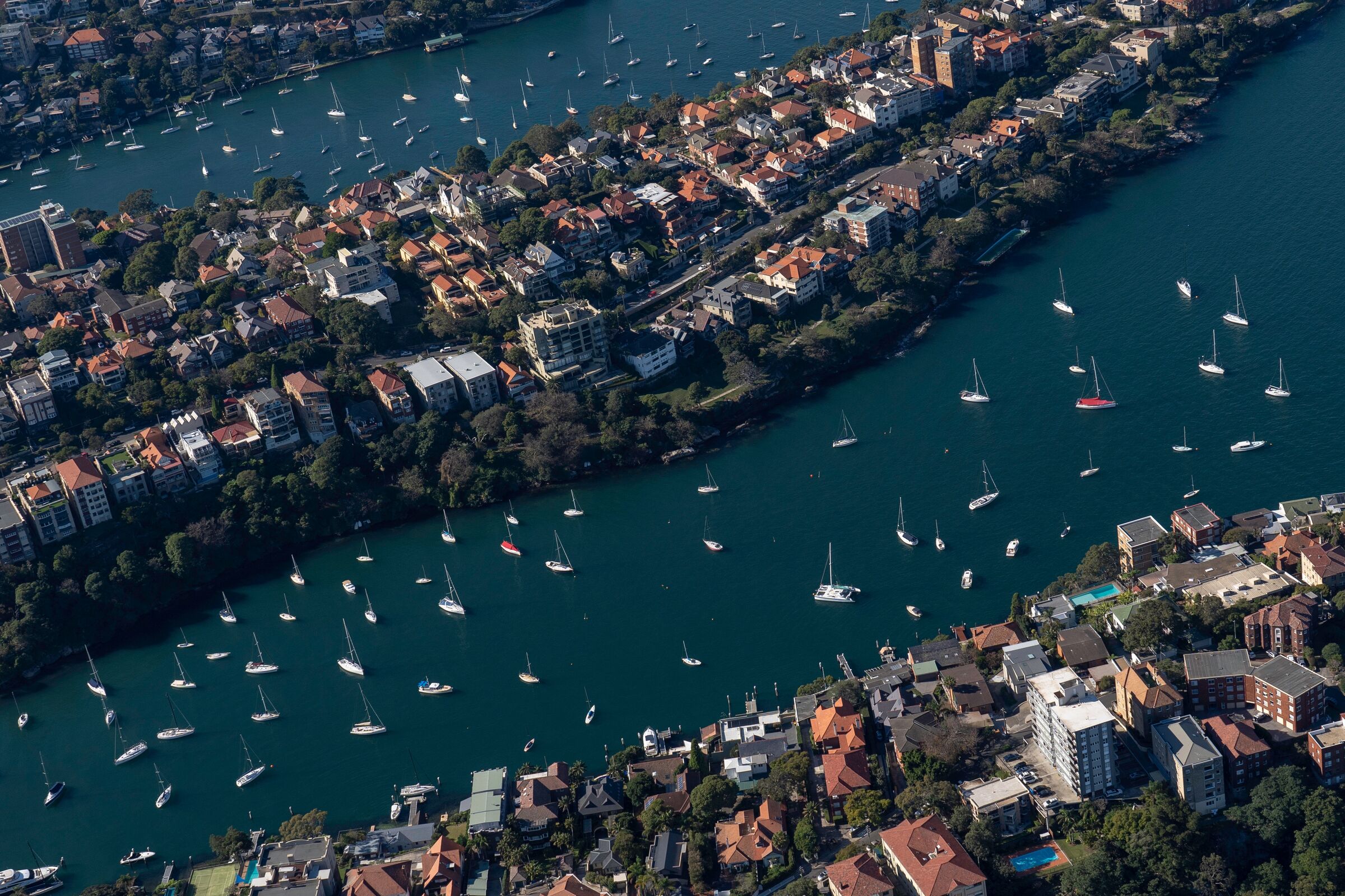 aerial view of sydney's northern harbourside suburbs with moored yachts on the water