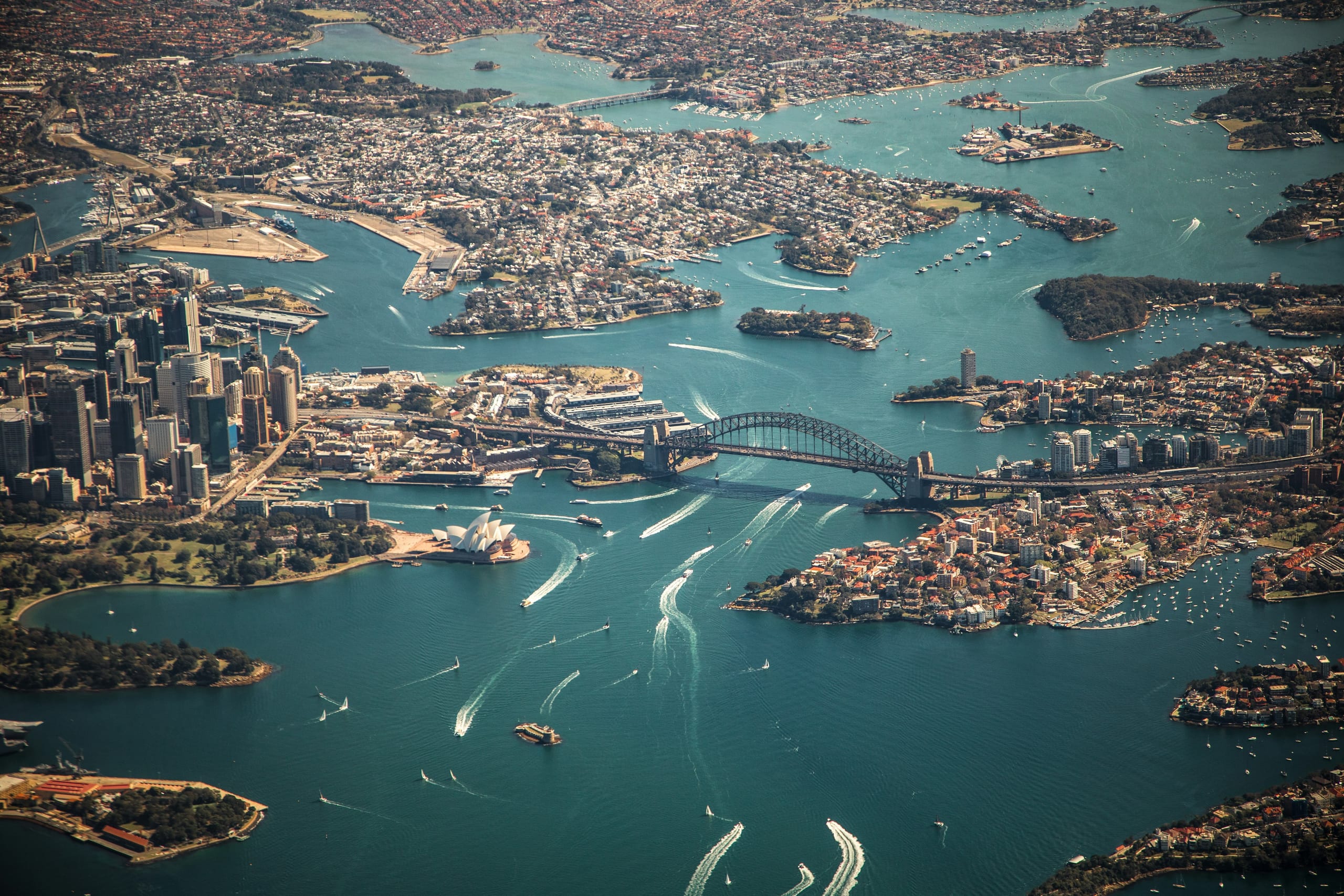 aerial view of an australian city skyline and water at dusk