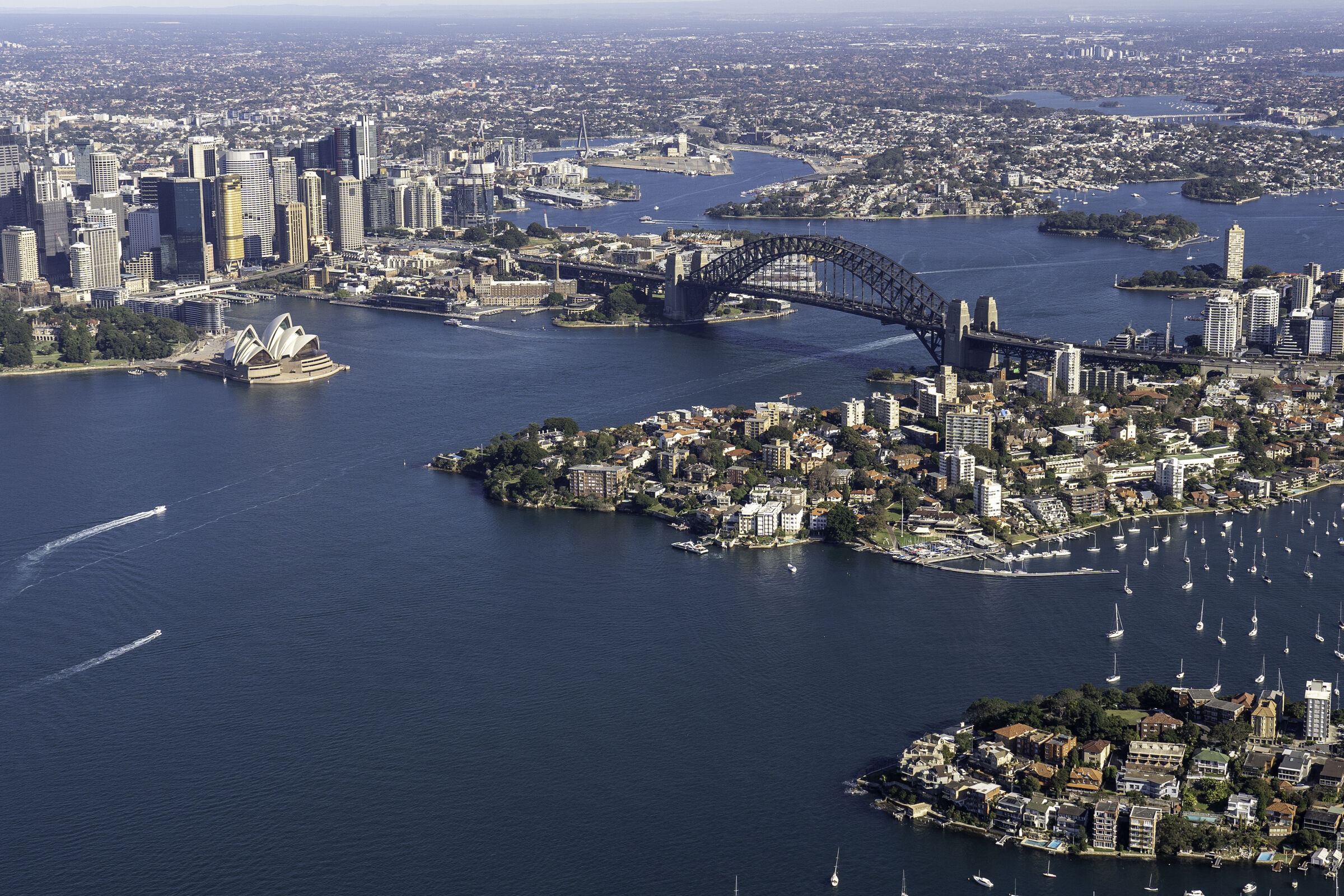 aerial daytime view of sydney harbour bridge, the opera house and the city skyline